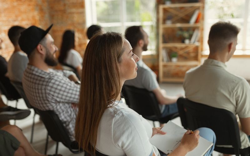 independent contractors sitting in a classroom setting for a sexual harassment training