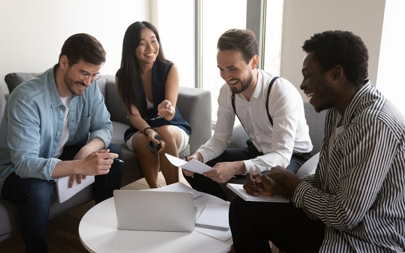 Happy diverse team people laughing at work