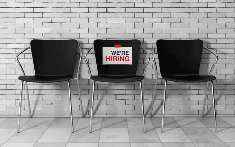 Empty chairs and we are hiring sign