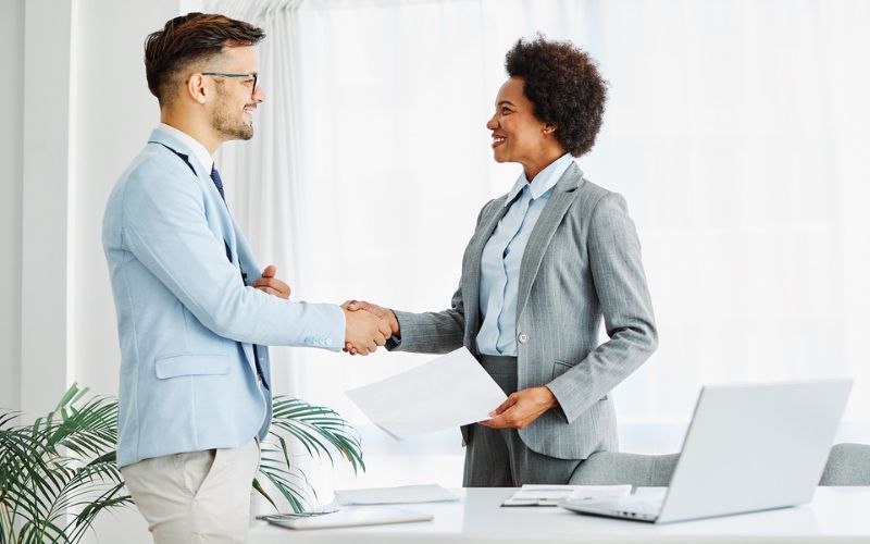 Two diverse people shaking hands