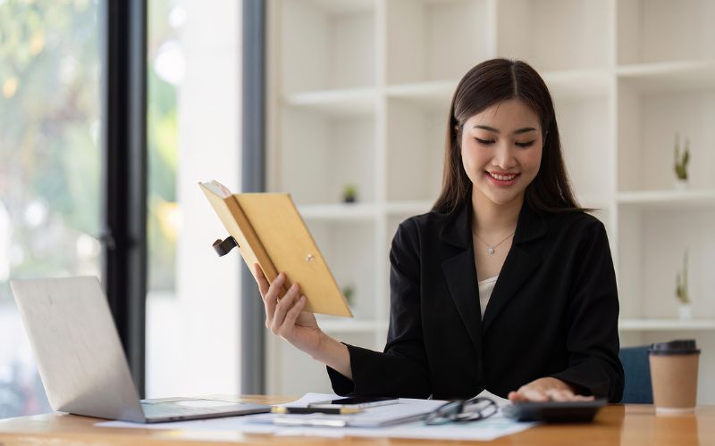 Woman smiling and working on calculations