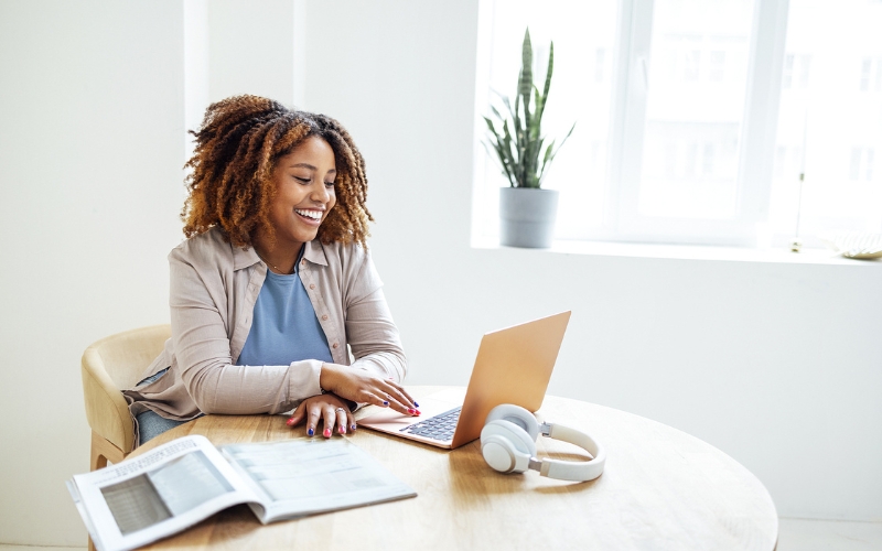 Young woman working from home table on laptop